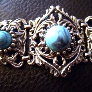 Southwestern Ornate Bracelet. Turquoise Colored with purple swirls. Length is ab